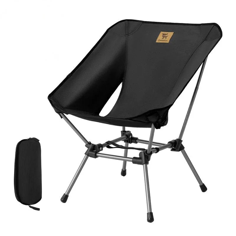 Black folding chair with carrying case on a white background